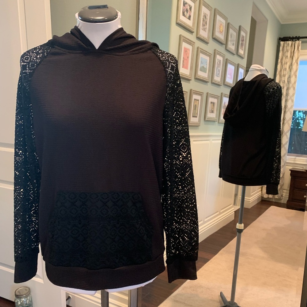 Small black hoodie with lace sleeves and pocket.